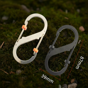 Two carabiners on a mossy background with measurements indicated.